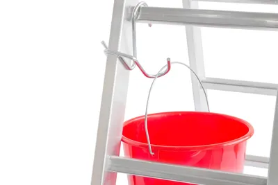 A red bucket hangs from a hook attached to a silver ladder.