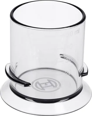 A clear plastic measuring cup with black trim and markings for volume.