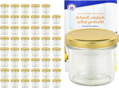 A set of small glass jars with gold lids is displayed next to a recipe booklet.