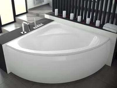 A modern corner bathtub in a bathroom setting.