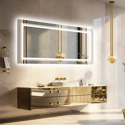 A modern bathroom vanity with a large illuminated mirror.