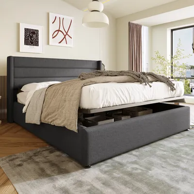A bedroom scene with a bed and artwork on the wall.