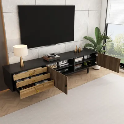 A modern living room with a TV stand and a large television mounted on the wall.
