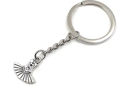 Productafbeelding van Onwomania korsetkostuum sleutelhanger, metalen geluksbringer in een aluminium cadeauverpakking, ideaal om cadeau te geven