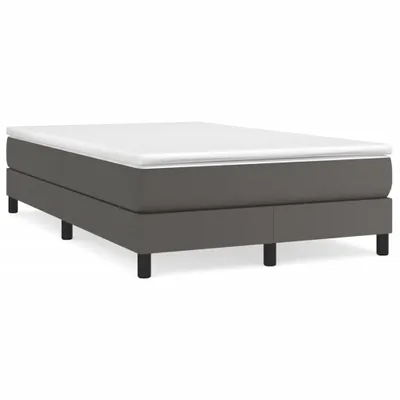 A studio shot of a bed frame with a mattress on top, against a white background.