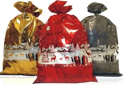 Three Christmas-themed gift bags in gold, red, and gray are displayed against a white background.