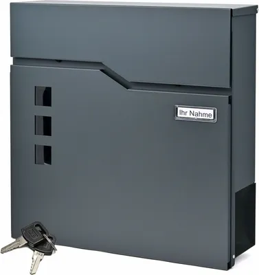 A dark gray mailbox with a newspaper compartment and keys in the foreground.