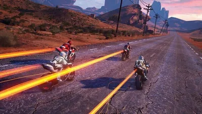 Motorcycles racing on a desert road with glowing trails.