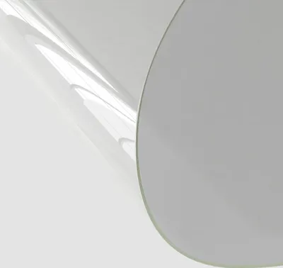 A close-up of a transparent plastic sheet with a curved edge.