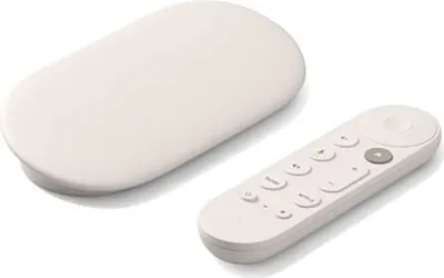 A white Google TV streamer and its remote control are shown on a white background.
