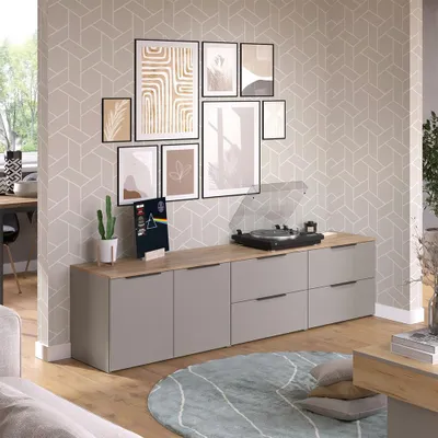 A living room scene featuring a media console with a record player and artwork on the wall.