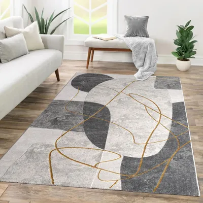 A modern living room with a sofa, rug, and bench.