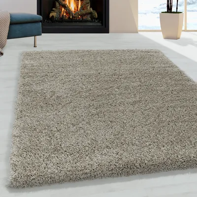 A shaggy rug in a living room setting with a fireplace and a stool.