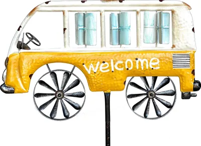 A decorative metal garden stake shaped like a vintage yellow and white camper van.