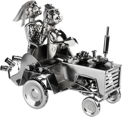 A metallic sculpture of a wedding couple on a tractor.