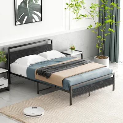 A bedroom scene with a bed, nightstands, and a plant.