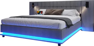 A modern upholstered bed with integrated LED lighting and bedside units.