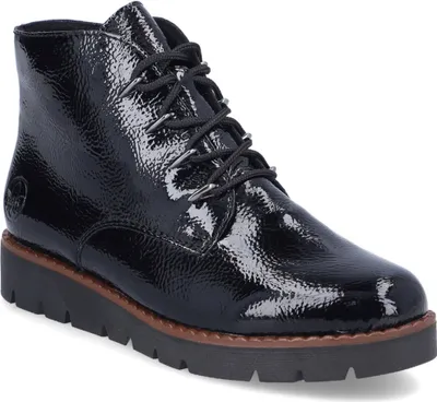 A black patent leather lace-up boot with a thick sole.