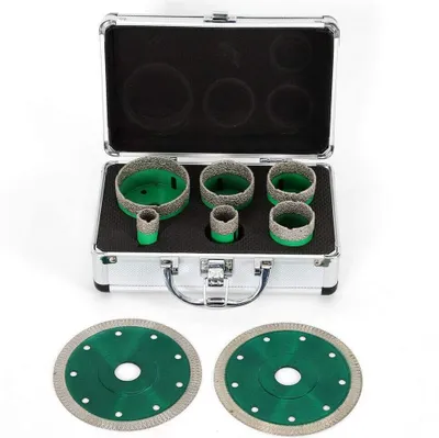 A set of diamond drill bits and circular saw blades are displayed in an open aluminum case.