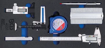 A set of measuring tools laid out in a foam insert.