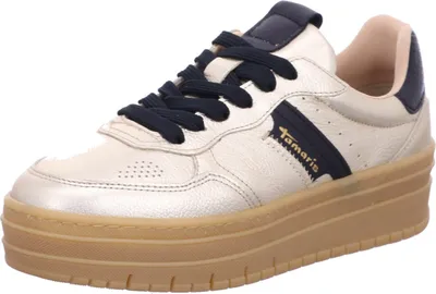 A single gold sneaker with navy blue accents and laces, set against a white background.