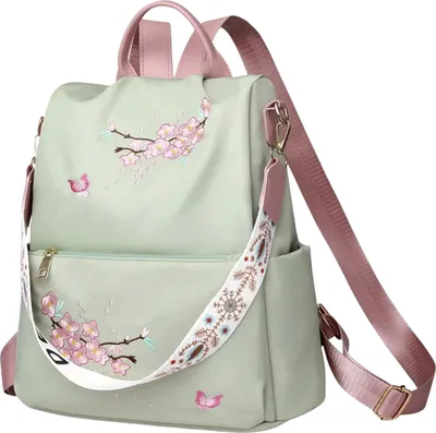 A light green backpack with pink accents and floral embroidery, displayed against a white background.