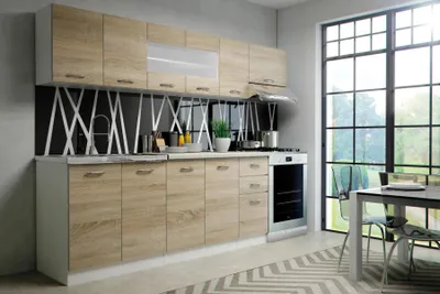 A modern kitchen setup with light wood cabinets and a large window overlooking greenery.