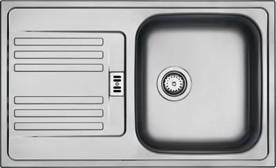 A top-down view of a stainless steel kitchen sink with a drainboard.