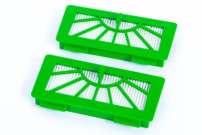 Two green vacuum cleaner filters are shown against a white background.