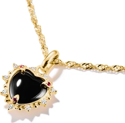 A close-up shot of a heart-shaped pendant necklace with a black stone, surrounded by small red and white stones, on a gold chain.