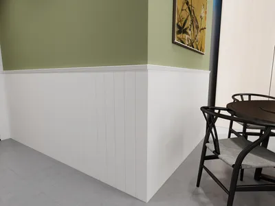 A corner of a room with wainscoting and a painting on the wall, and a table with chairs.