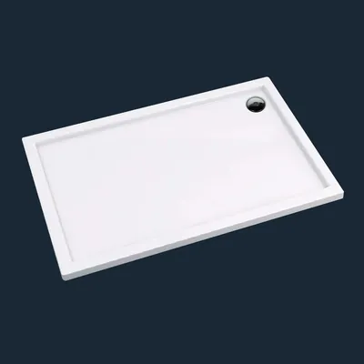 A white rectangular shower tray with a drain hole is shown against a dark blue background.