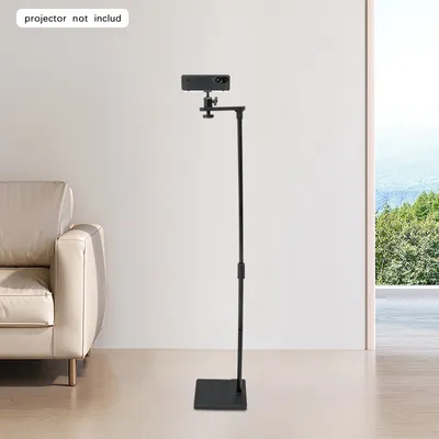 A black projector stand is shown in a room with a couch and a window with a view of trees and mountains.
