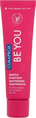 A pink tube of Curaprox toothpaste against a white background.