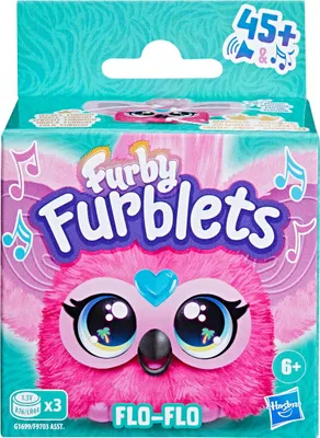 The image shows the packaging of a Furby Furblet toy. The packaging is brightly colored with images of musical notes and the Furby character.