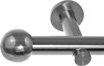 Close-up of a metal curtain rod with a spherical finial and a wall bracket.