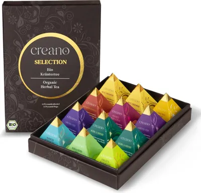 A box of assorted herbal teas, with the lid open to reveal pyramid-shaped tea bags arranged in rows.