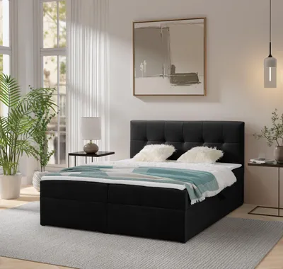 A bedroom scene with a bed, nightstand, plant, and artwork.