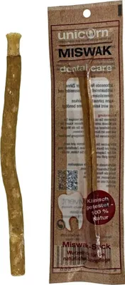 A miswak stick is shown next to its packaging.