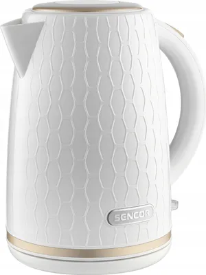 A white electric kettle with a textured honeycomb pattern and gold accents.