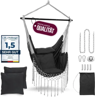 A dark gray hanging chair with cushions, suspended from a bar, with various accessories laid out around it.