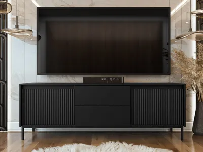 A black TV stand with a large television mounted above it, in a modern living room setting.