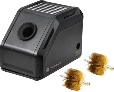 A black soldering tip cleaner with two brass brushes.
