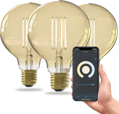 A hand holding a smartphone displaying a smart lamp control app, with three smart LED bulbs in the background.