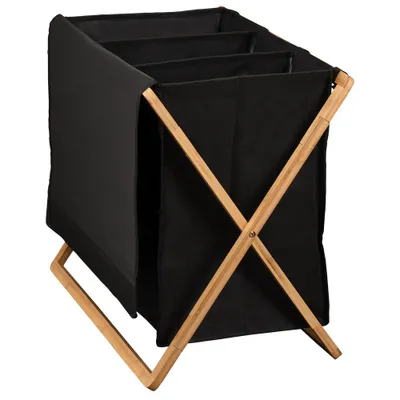 A black, three-compartment laundry hamper with a bamboo frame, shown from a three-quarter angle against a white background.