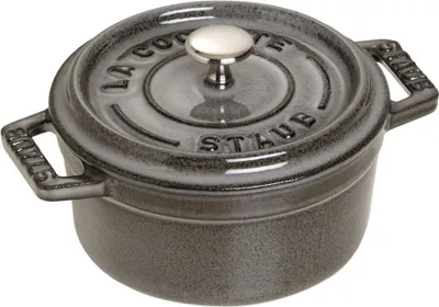 A close-up studio shot of a Staub mini cocotte.