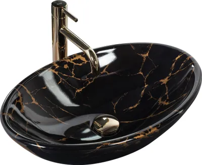 A black and gold marble effect vessel sink with a gold faucet.
