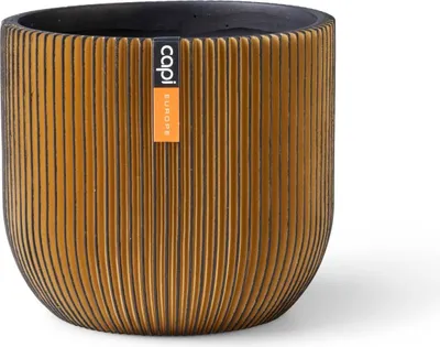A gold-colored planter pot with vertical grooves and a black interior, featuring a brand label.