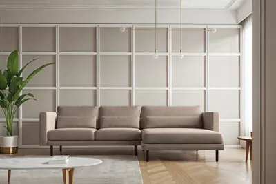 A modern living room with a sectional sofa, coffee table, and plant.