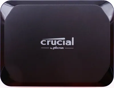 A close-up, top-down view of a black external SSD.